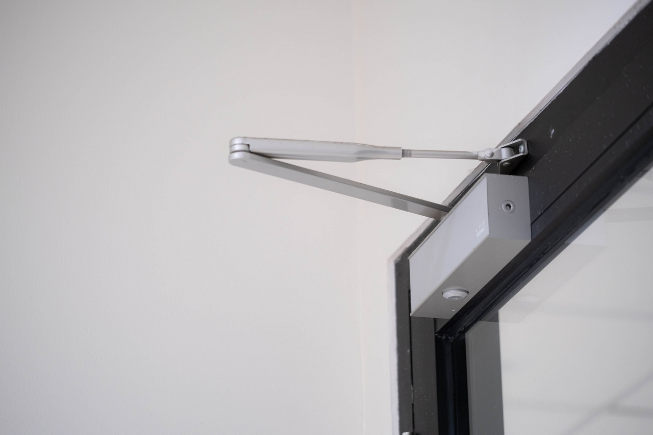 Storefront door closer repair technician